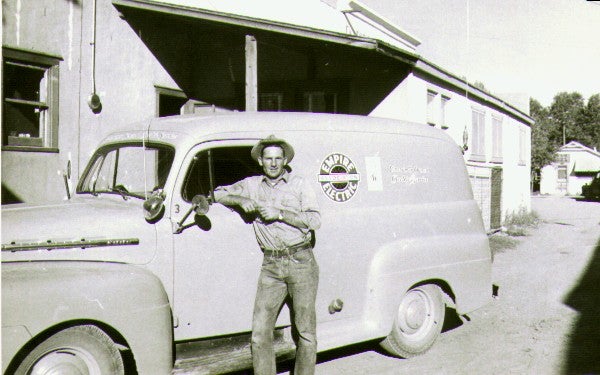 Lineman standing by old EEA van