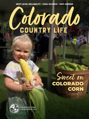 Colorado Country Life cover featuring a toddler eating a fresh ear of corn  