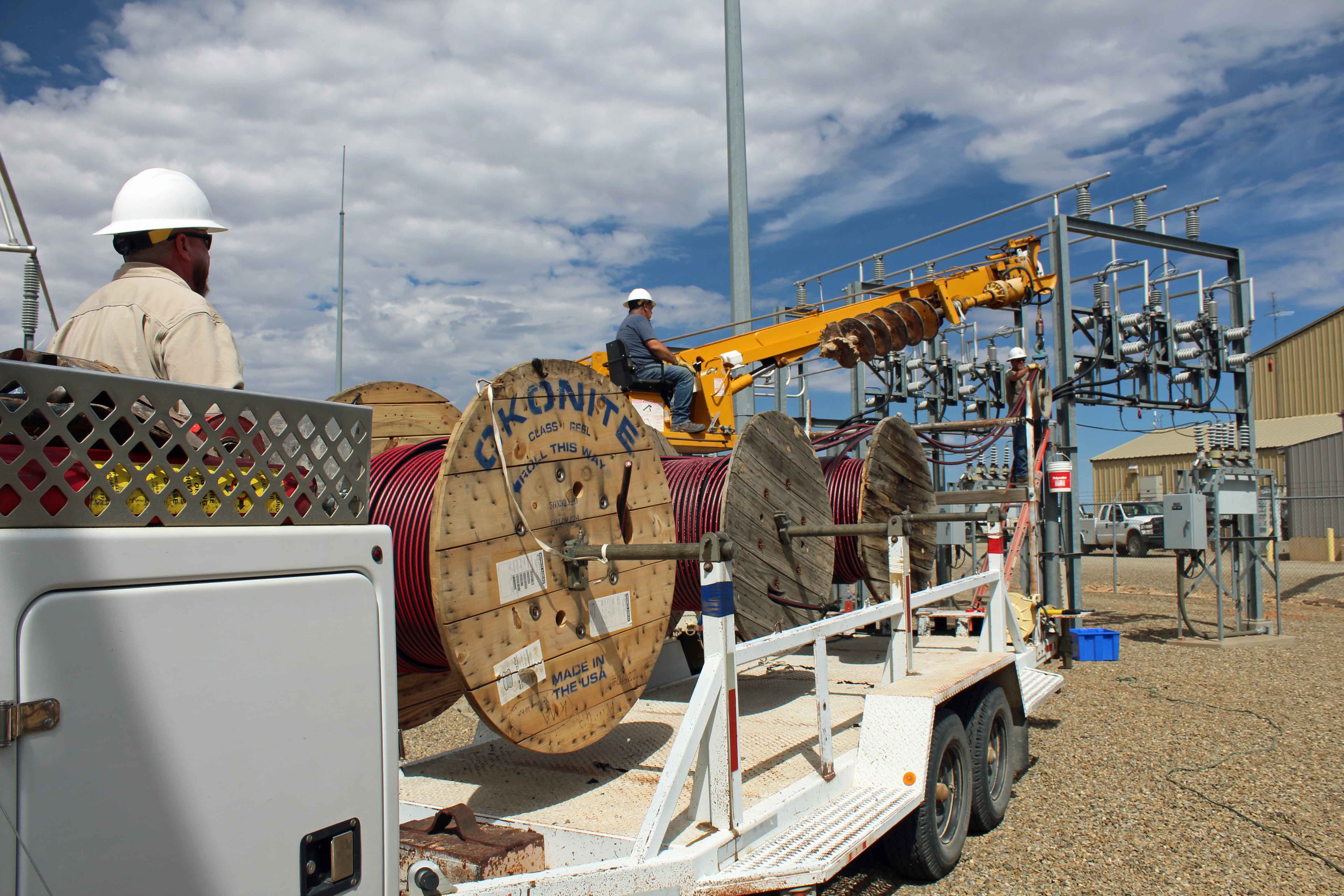 EEA lineman pulling large underground conductor at a substation